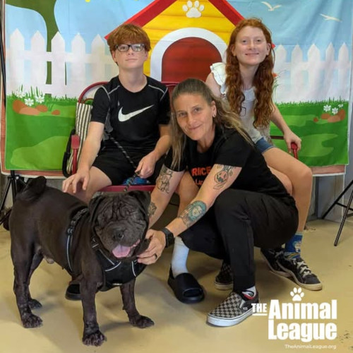 It's smiles from everyone, including Duke, as his new family (mom, brother and sister) have come to take him home.