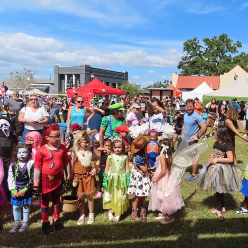 Amongst the crowds and gazebos, children line up to show off their costumes; pink fairies, cowgirls, zombies and more.