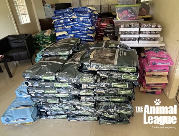 Large bags of dry dog and cat food are piled high, and almost fill the floor of one of our storage rooms.