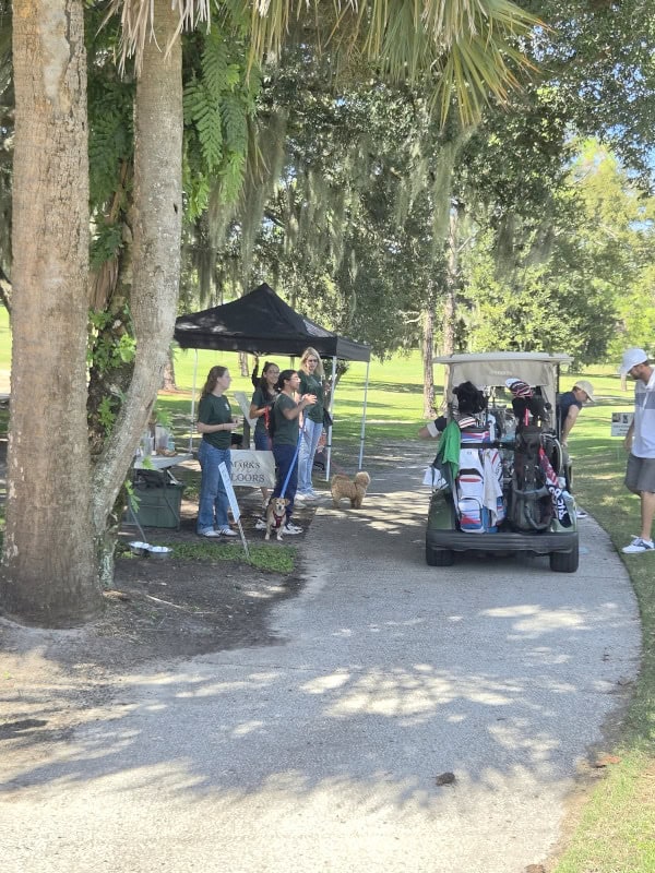 Players travel around the course in their golf carts, stopping to say hello to some of the dogs from The Animal League and chat with volunteers.